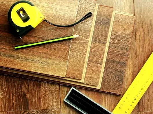 Measuring tapes and wooden flooring planks